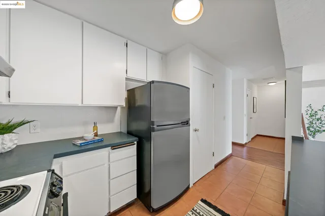 a kitchen with a refrigerator and a sink