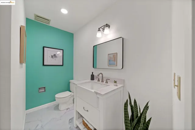 a bathroom with a toilet sink and mirror