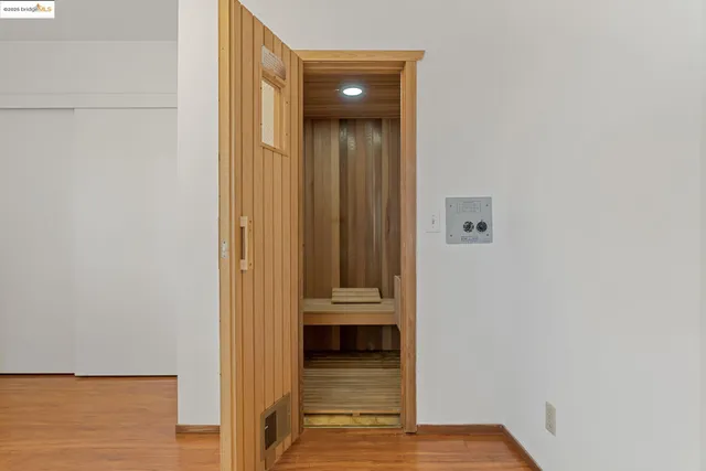 a view of a hallway with wooden floor and stairs