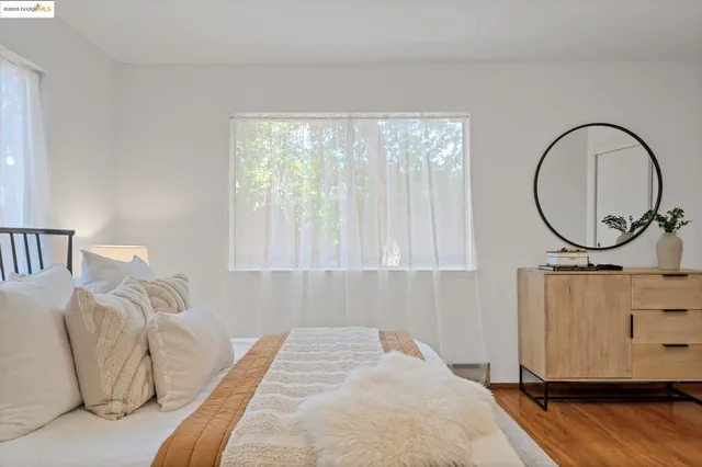 a bedroom with bed and a large window