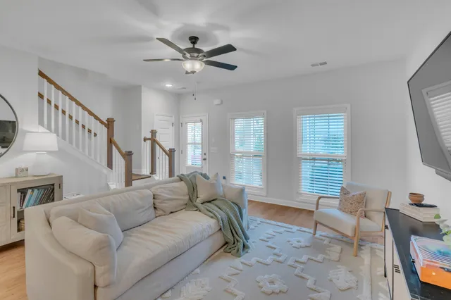 a view of staircase with wooden floor and mirror