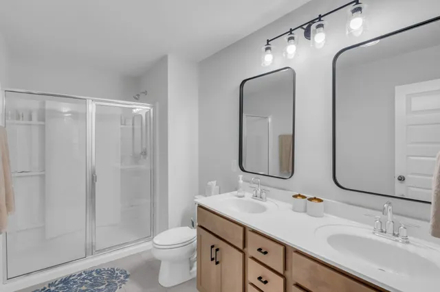 a bedroom with bed and a chandelier