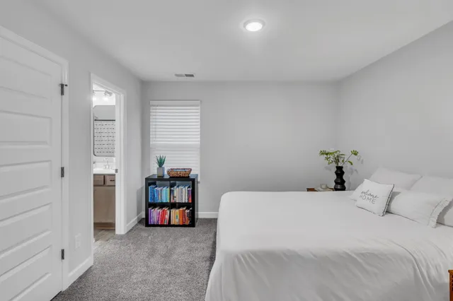 a bathroom with a granite countertop sink vanity mirror and toilet