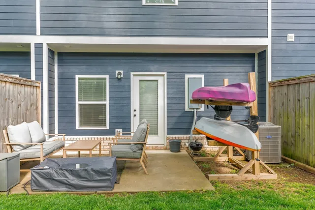 a backyard of a house with outdoor seating