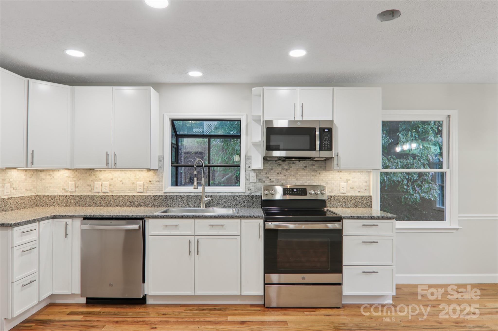 5 Timothy Lane Candler, NC 28715 - Photo 12 of 48 a kitchen with stainless steel appliances granite countertop a stove and a sink