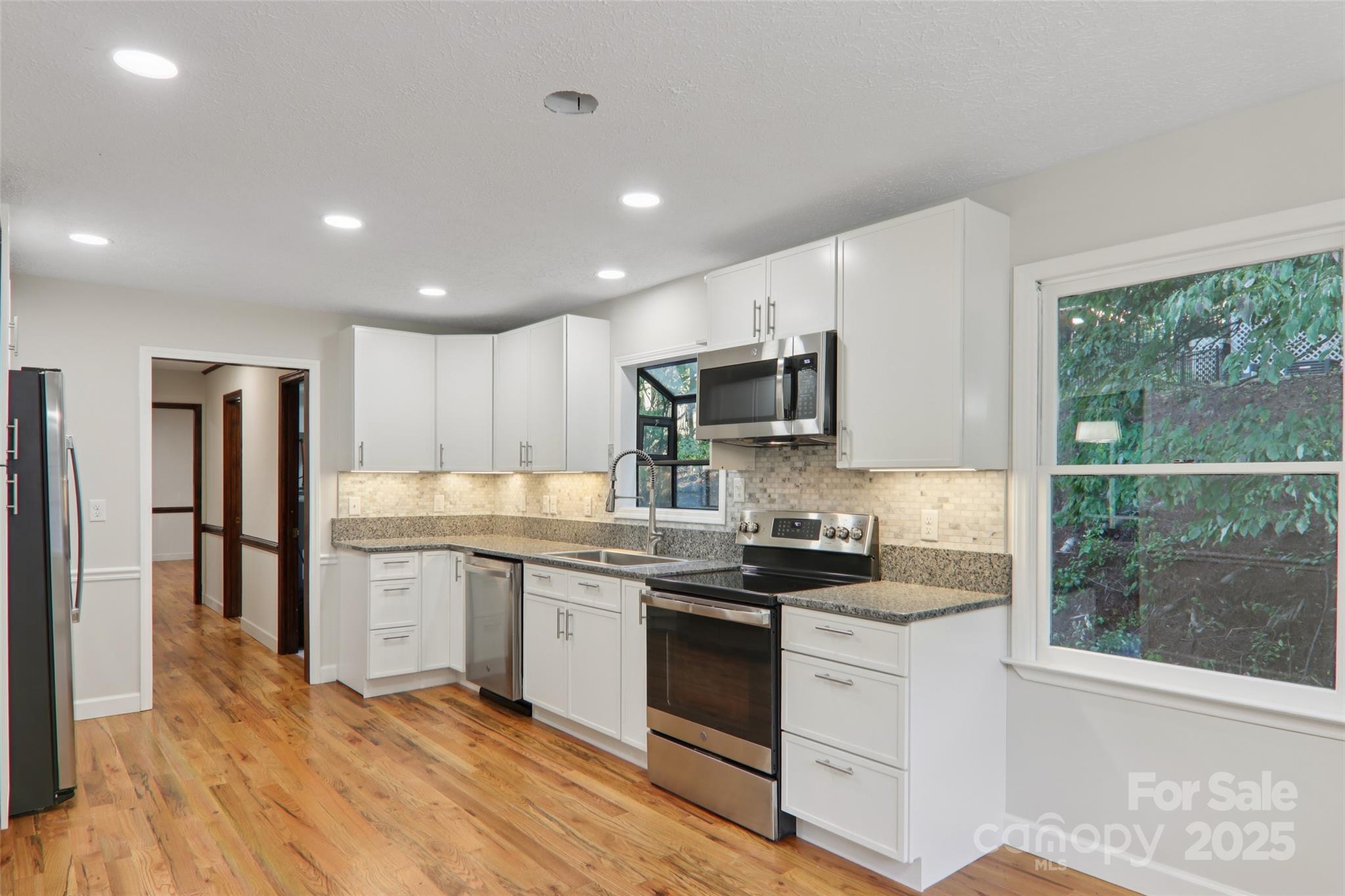5 Timothy Lane Candler, NC 28715 - Photo 13 of 48 a kitchen with a sink stainless steel appliances and white cabinets