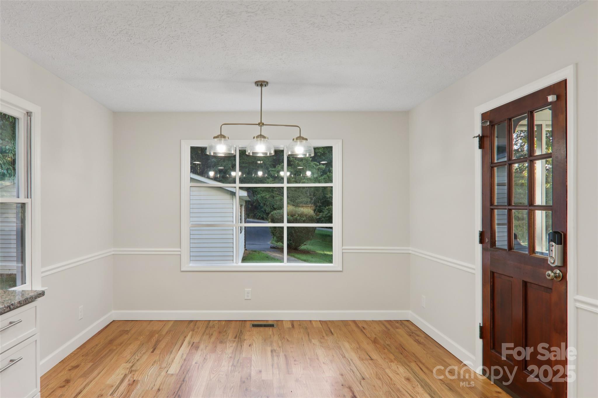 5 Timothy Lane Candler, NC 28715 - Photo 17 of 48 a view of a room with wooden floor chandeliers and kitchen