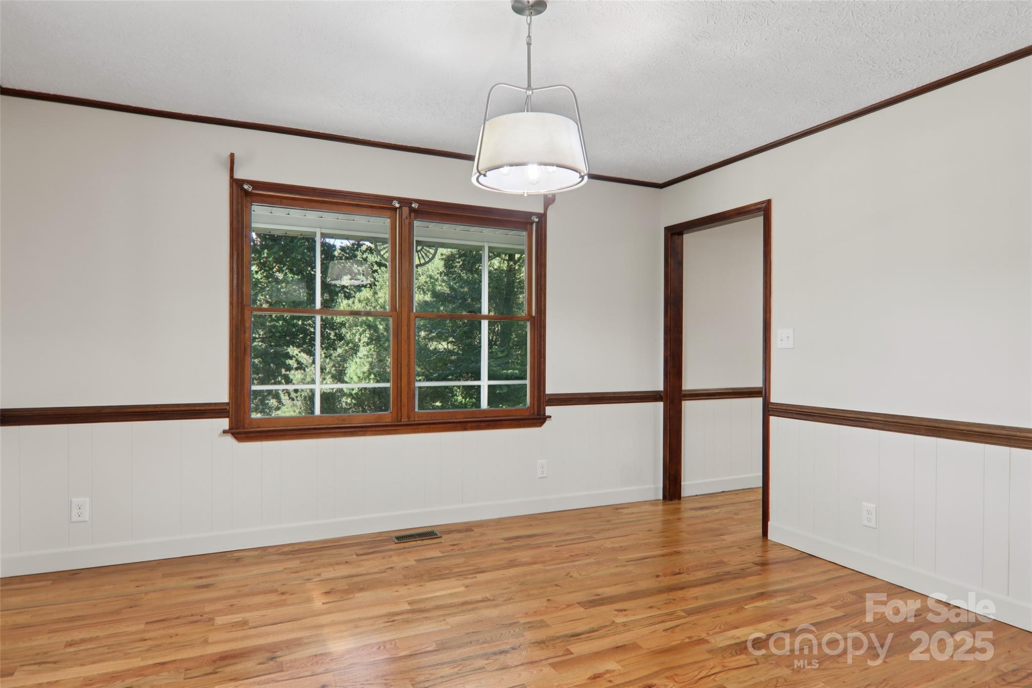 5 Timothy Lane Candler, NC 28715 - Photo 18 of 48 a view of an empty room with wooden floor and a window