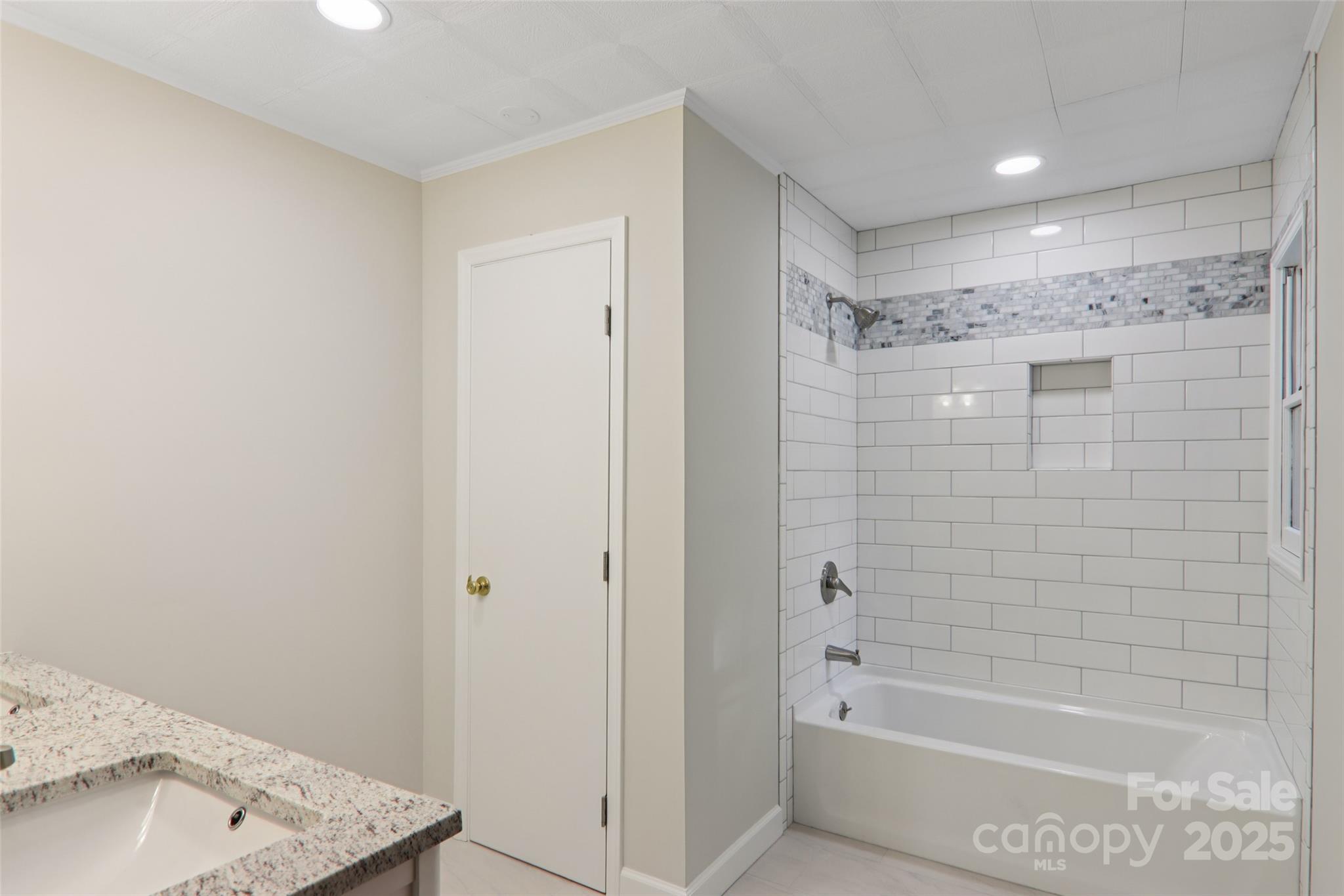 5 Timothy Lane Candler, NC 28715 - Photo 24 of 48 a bathroom with a bathtub and shower