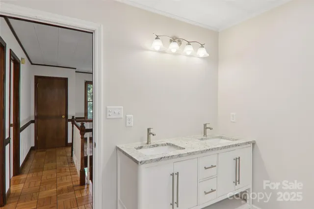 a bathroom with a double vanity sink and a mirror