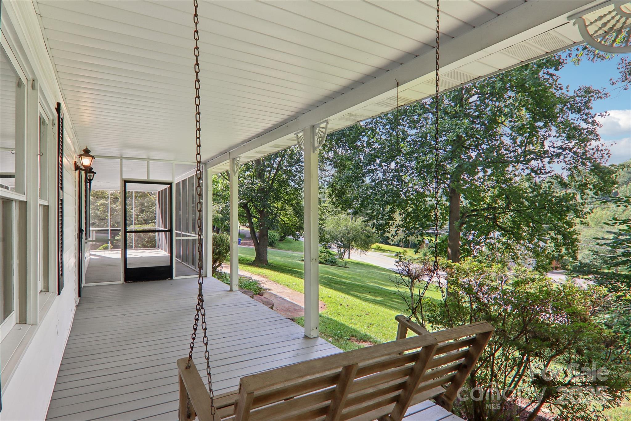 5 Timothy Lane Candler, NC 28715 - Photo 44 of 48 a view of a deck with a table and chairs under an umbrella