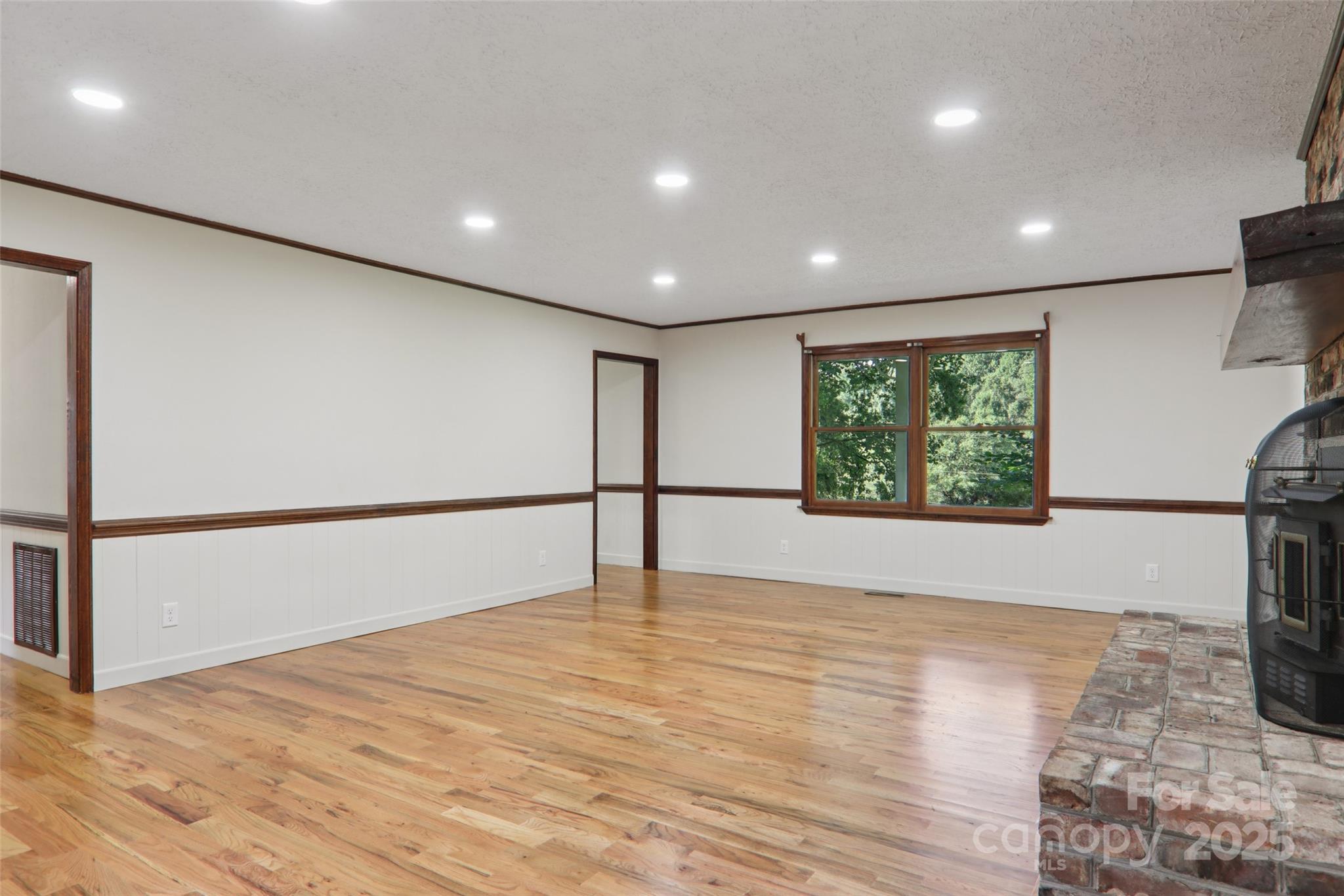 5 Timothy Lane Candler, NC 28715 - Photo 8 of 48 a view of an empty room with wooden floor and a window