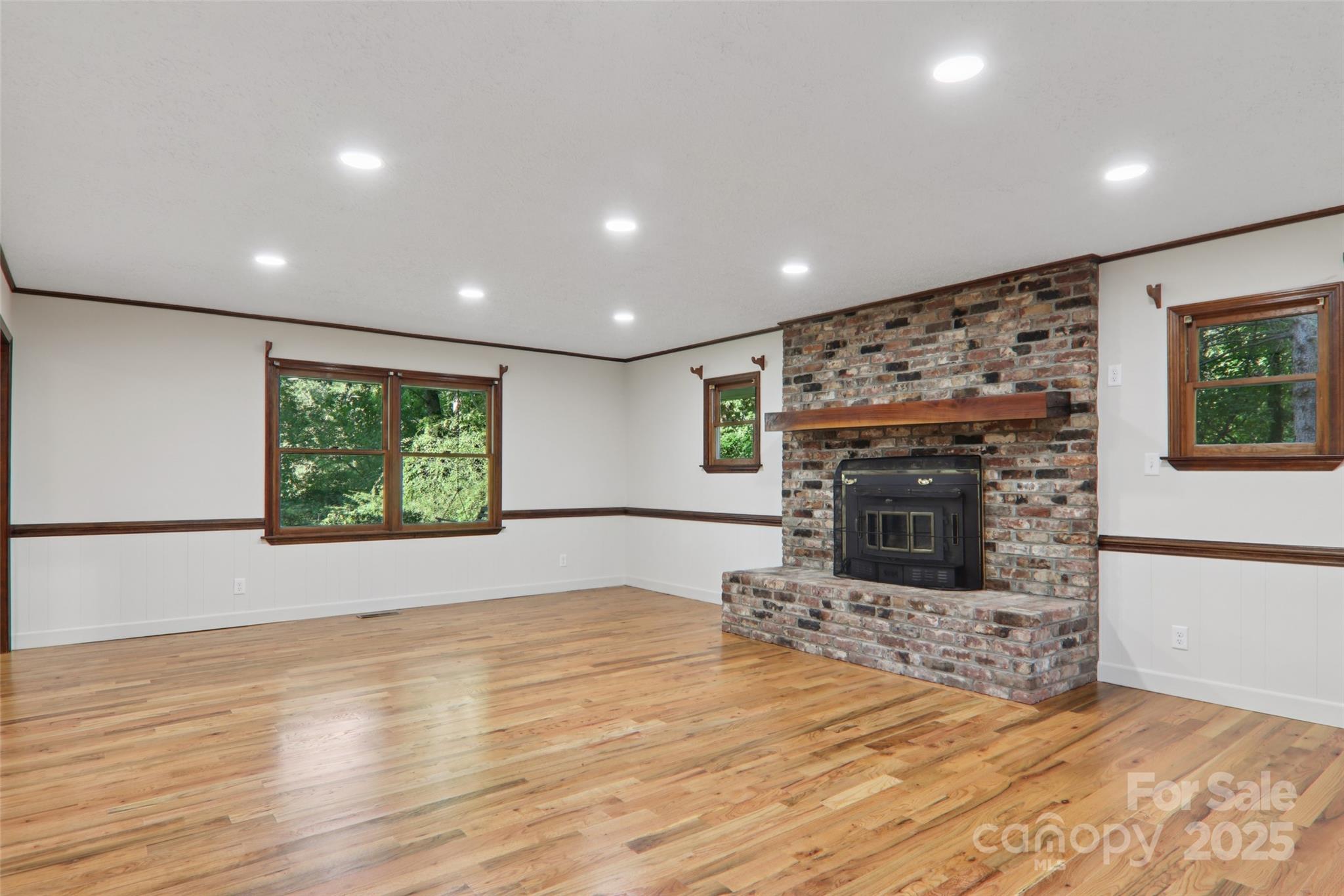 5 Timothy Lane Candler, NC 28715 - Photo 9 of 48 a view of empty room with wooden floor and fireplace