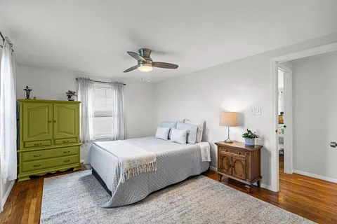 a bedroom with a bed and a mirror