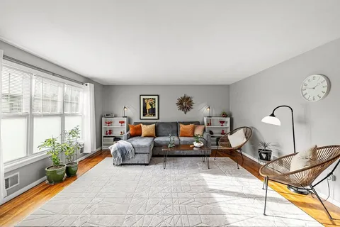 a living room with furniture potted plant and a window