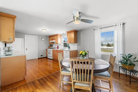 a view of a dining room with furniture and wooden floor