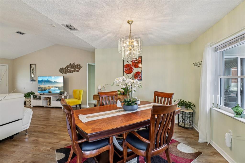 2963 Southwest 137th Place Ocala, FL 34473 - Photo 11 of 51 a view of a dining room with furniture window and wooden floor