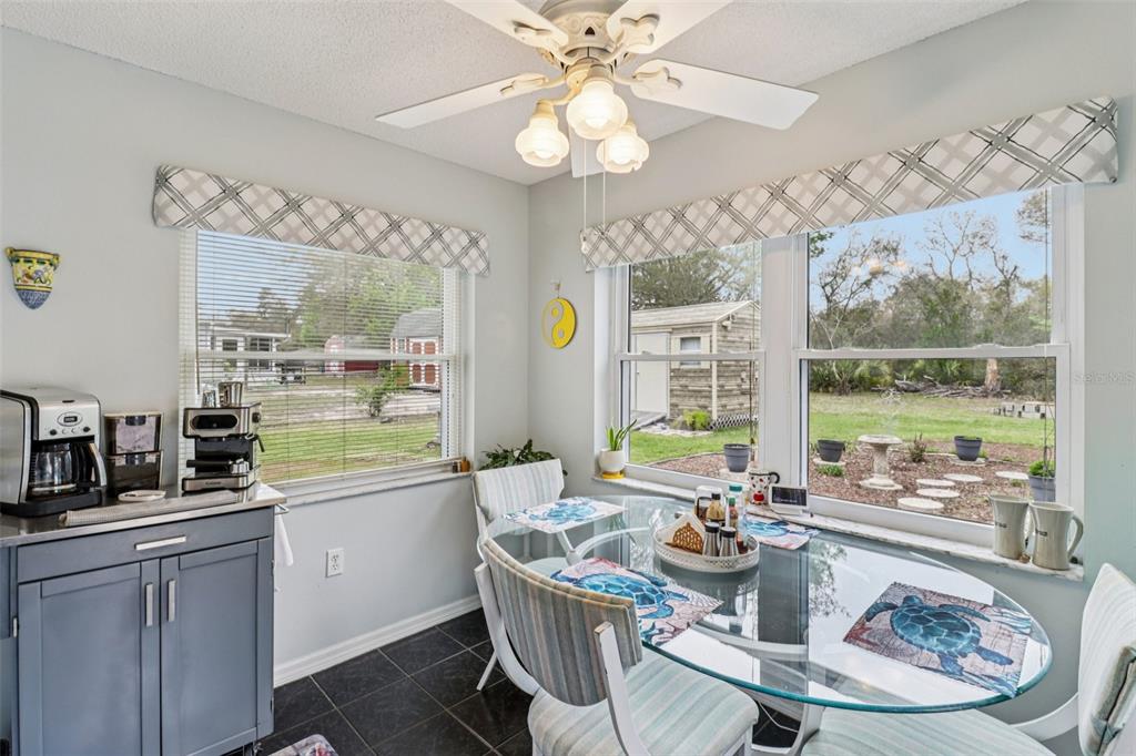 2963 Southwest 137th Place Ocala, FL 34473 - Photo 13 of 51 a dining room with furniture a large window and a chandelier