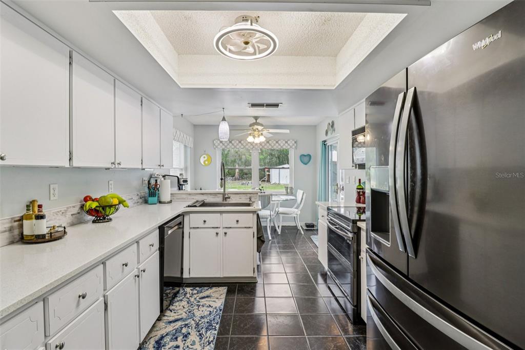 2963 Southwest 137th Place Ocala, FL 34473 - Photo 14 of 51 a kitchen with a refrigerator and a sink