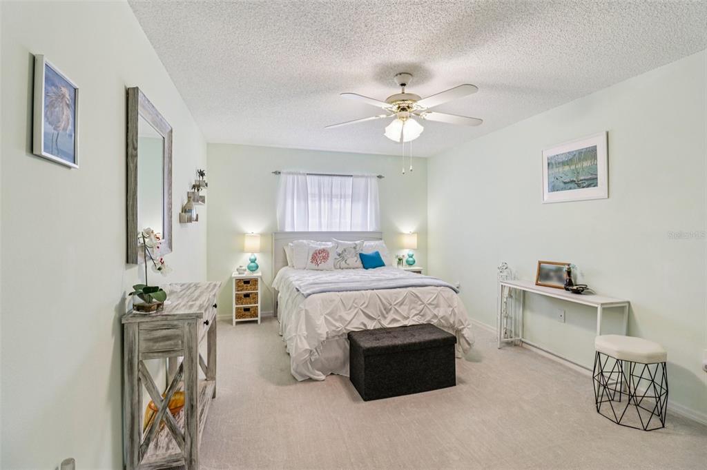 2963 Southwest 137th Place Ocala, FL 34473 - Photo 18 of 51 a bed room with a bed and a chandelier