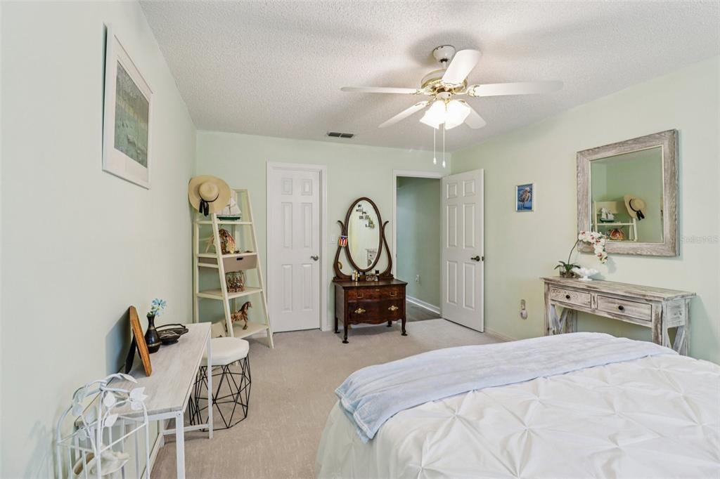 2963 Southwest 137th Place Ocala, FL 34473 - Photo 19 of 51 a bedroom with a bed and a chandelier