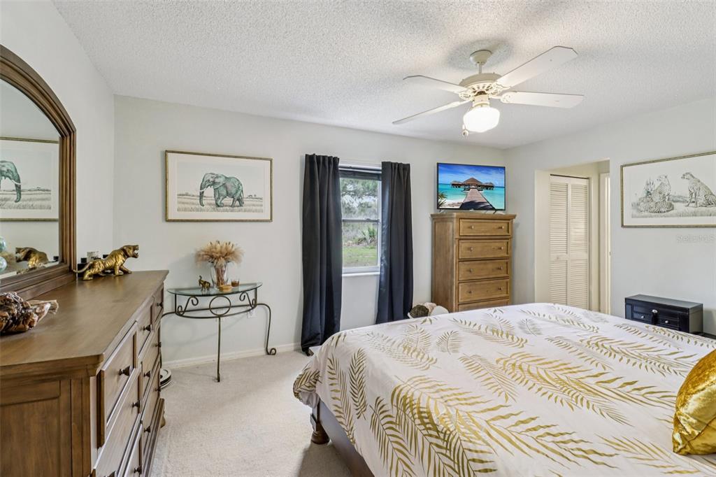 2963 Southwest 137th Place Ocala, FL 34473 - Photo 20 of 51 a bedroom with a bed and a dresser