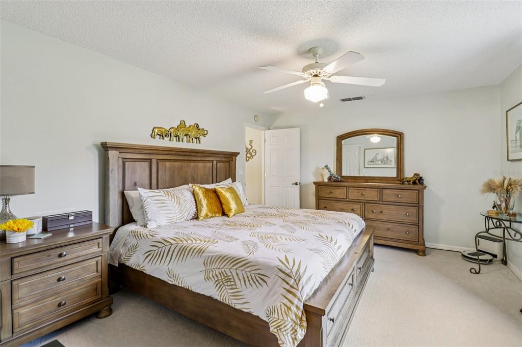 2963 Southwest 137th Place Ocala, FL 34473 - Photo 21 of 51 a bedroom with a bed and a chandelier