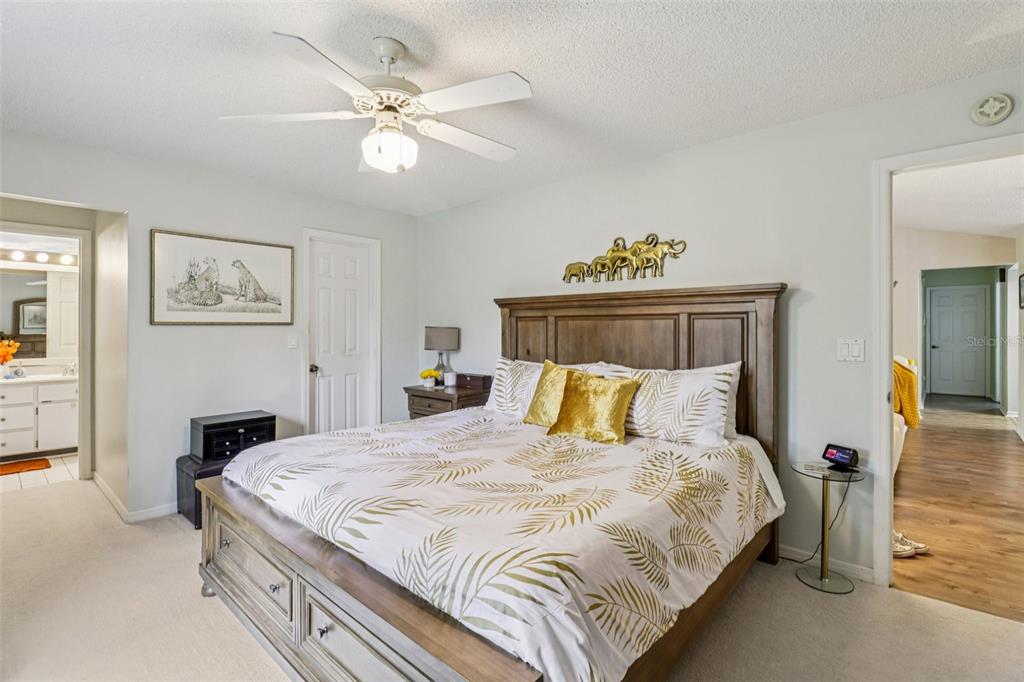 2963 Southwest 137th Place Ocala, FL 34473 - Photo 22 of 51 a bedroom with a bed and a chandelier