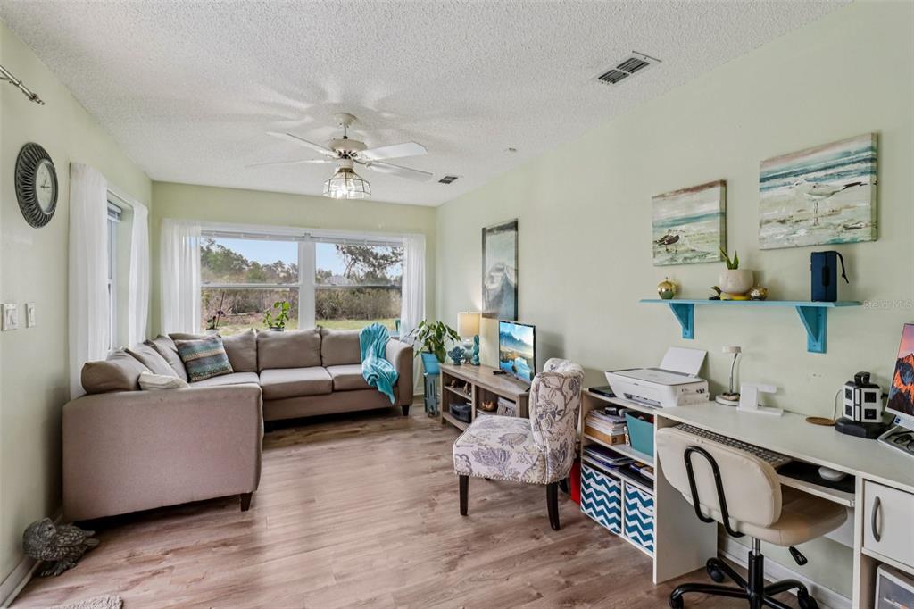 2963 Southwest 137th Place Ocala, FL 34473 - Photo 8 of 51 a living room with furniture and a large window
