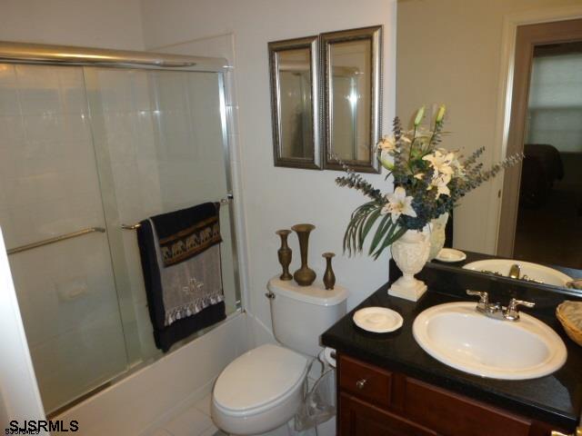 11 Northampton Road, Unit FOUR SEASONS Galloway Township, NJ 08205 - Photo 12 of 13 a bathroom with a toilet a sink and mirror