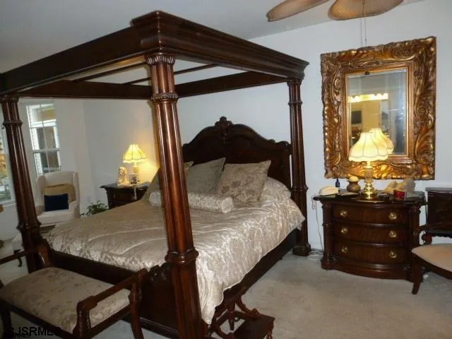 a bedroom with a bed window and dresser