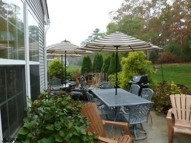 a view of a patio with table and chairs and potted plants