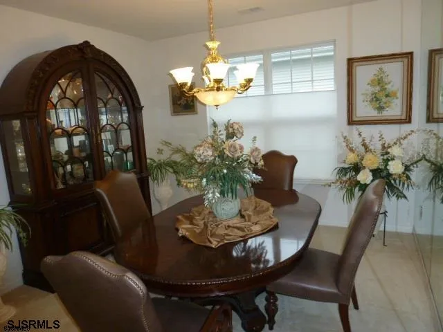 a view of a dining room with furniture and chandelier