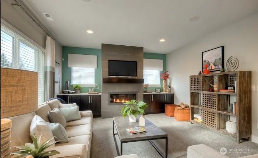 3606 200th Place Southeast Bothell, WA 98012 - Photo 4 of 28 a living room with furniture a flat screen tv and a fireplace