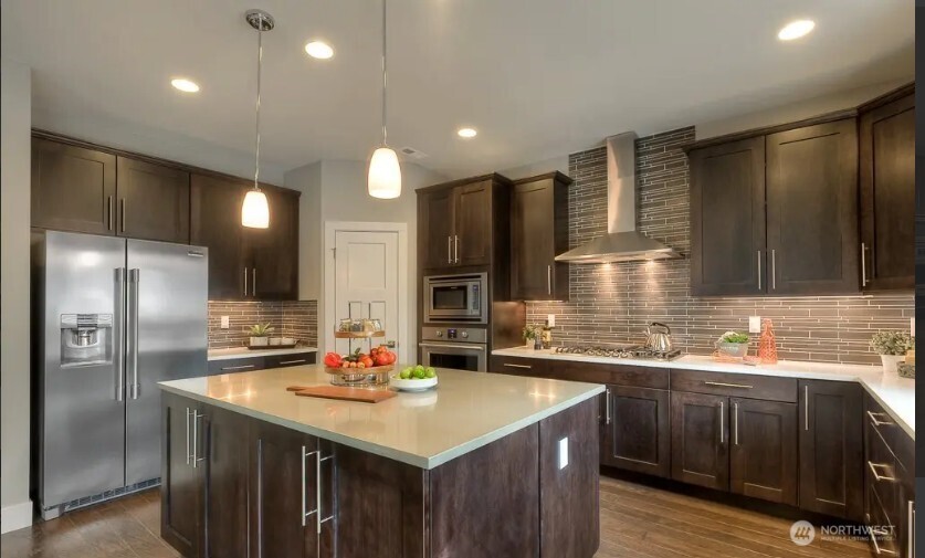 3606 200th Place Southeast Bothell, WA 98012 - Photo 8 of 28 a kitchen with stainless steel appliances granite countertop a sink refrigerator and cabinets