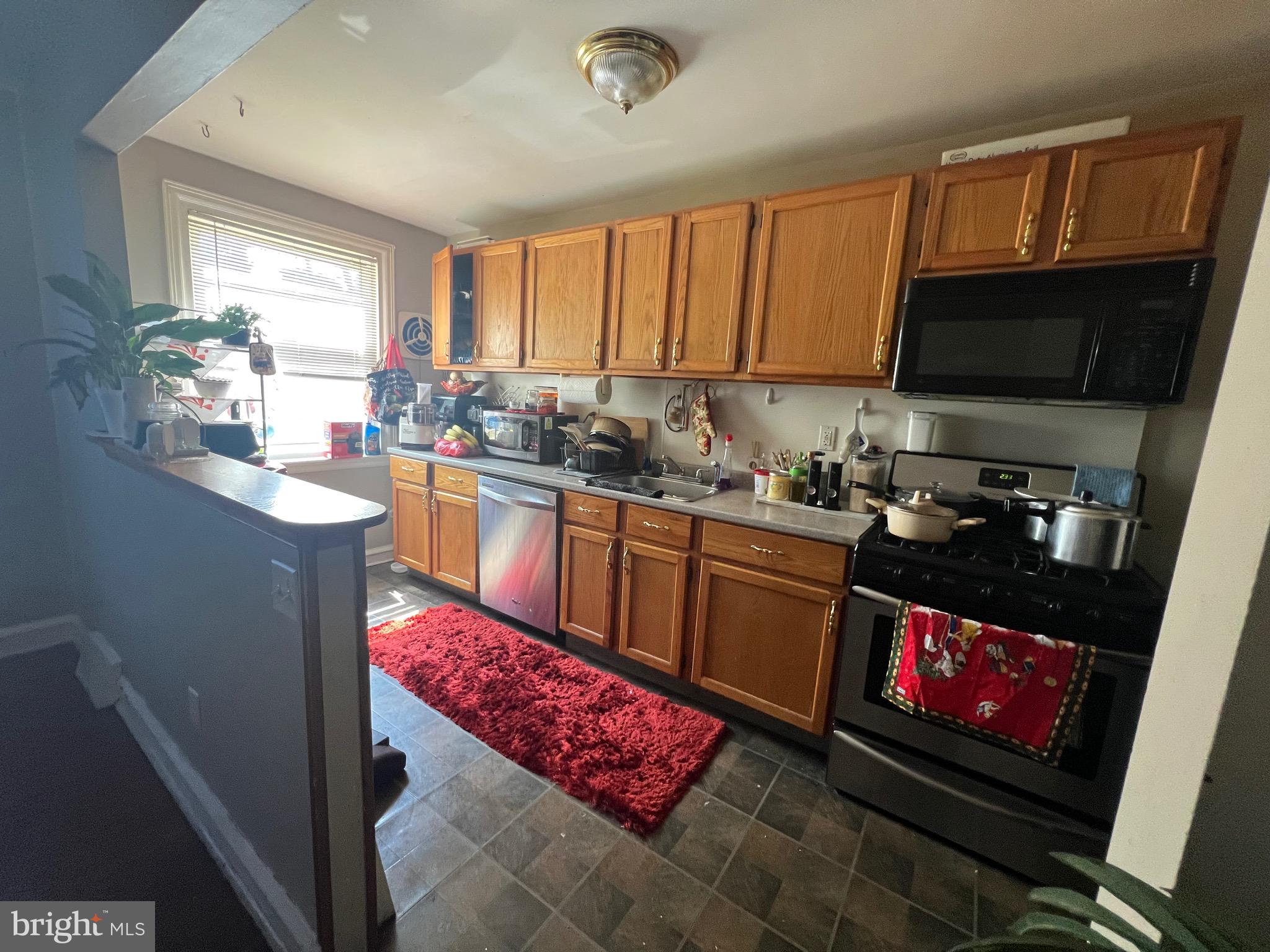 2818 Hellerman Street Philadelphia, PA 19149 - Photo 5 of 15 a kitchen with stainless steel appliances granite countertop a sink stove and cabinets
