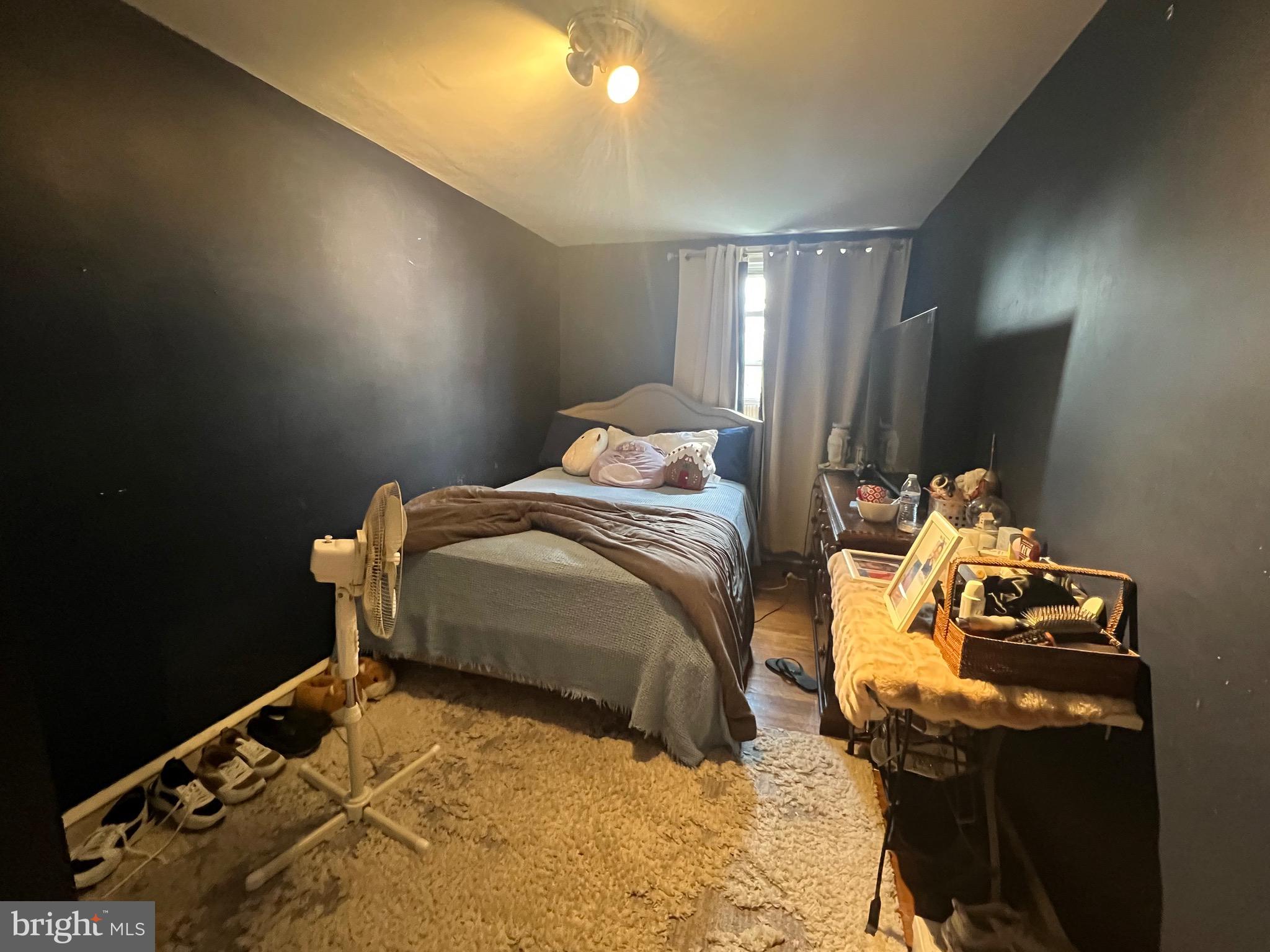 2818 Hellerman Street Philadelphia, PA 19149 - Photo 8 of 15 a bedroom with a bed and a flat tv screen on a dresser