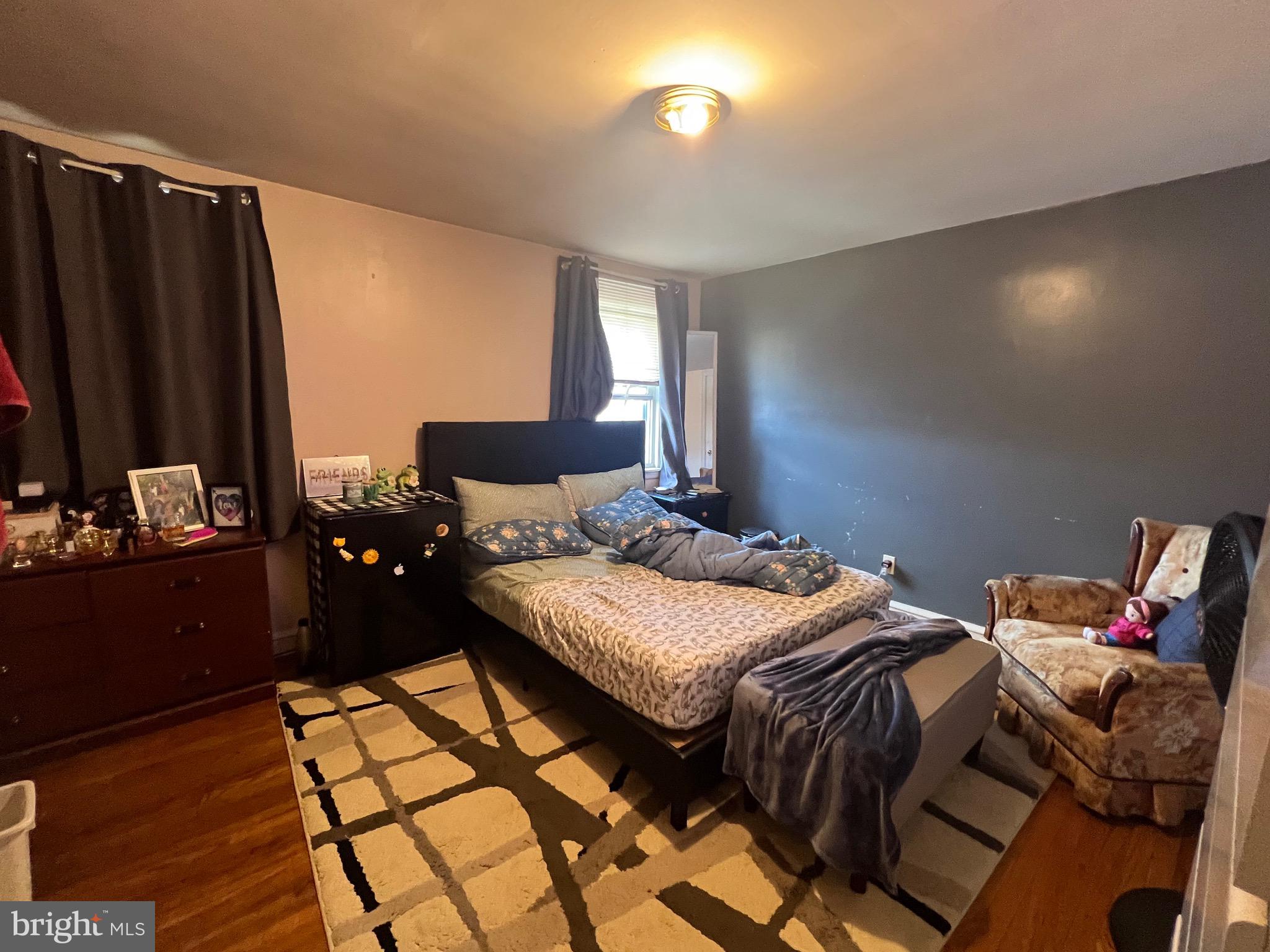 2818 Hellerman Street Philadelphia, PA 19149 - Photo 9 of 15 a bedroom with a bed and wooden floor