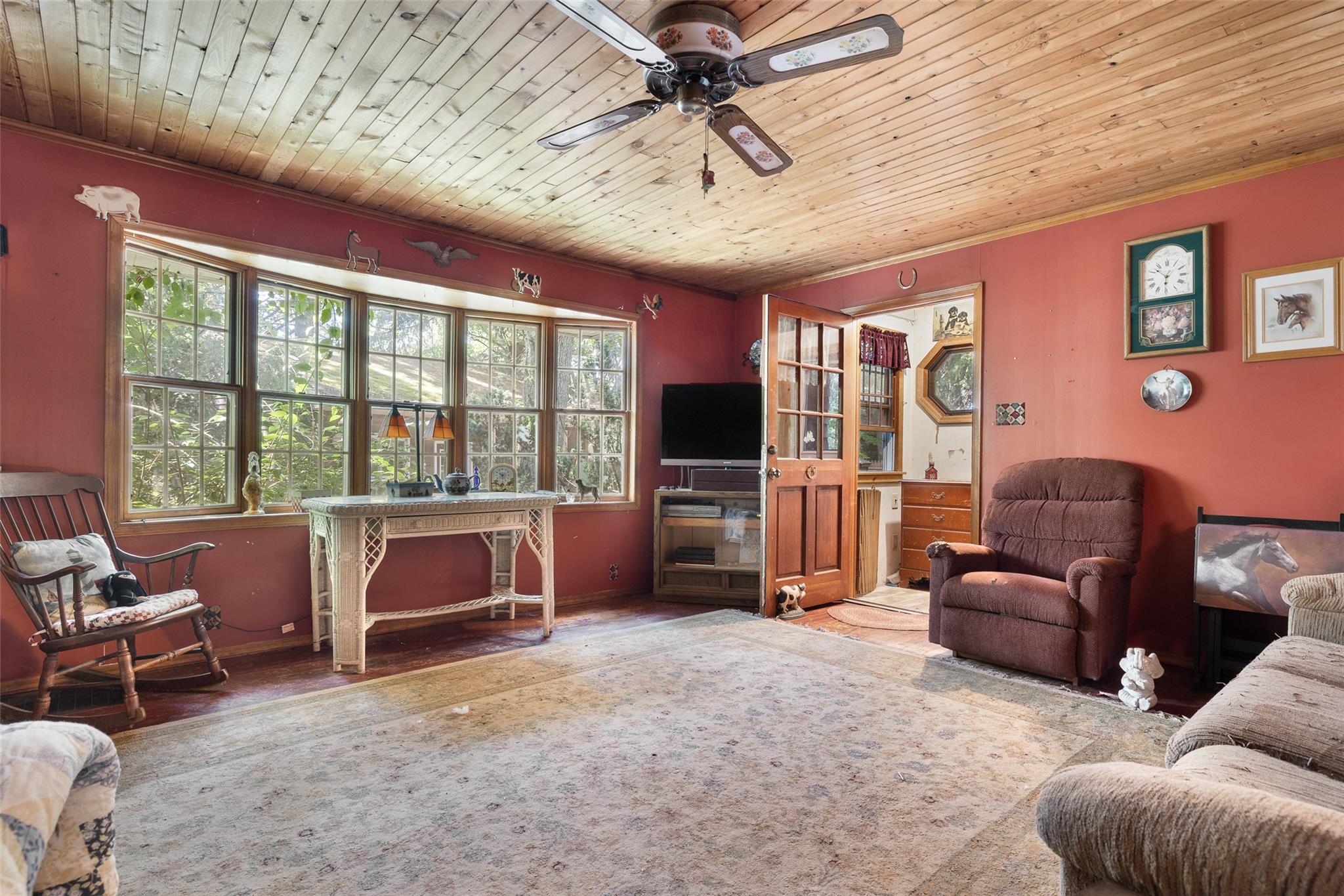 33 North Coleman Road Centereach, NY 11720 - Photo 11 of 40 Living room with crown molding, wooden ceiling, and a ceiling fan