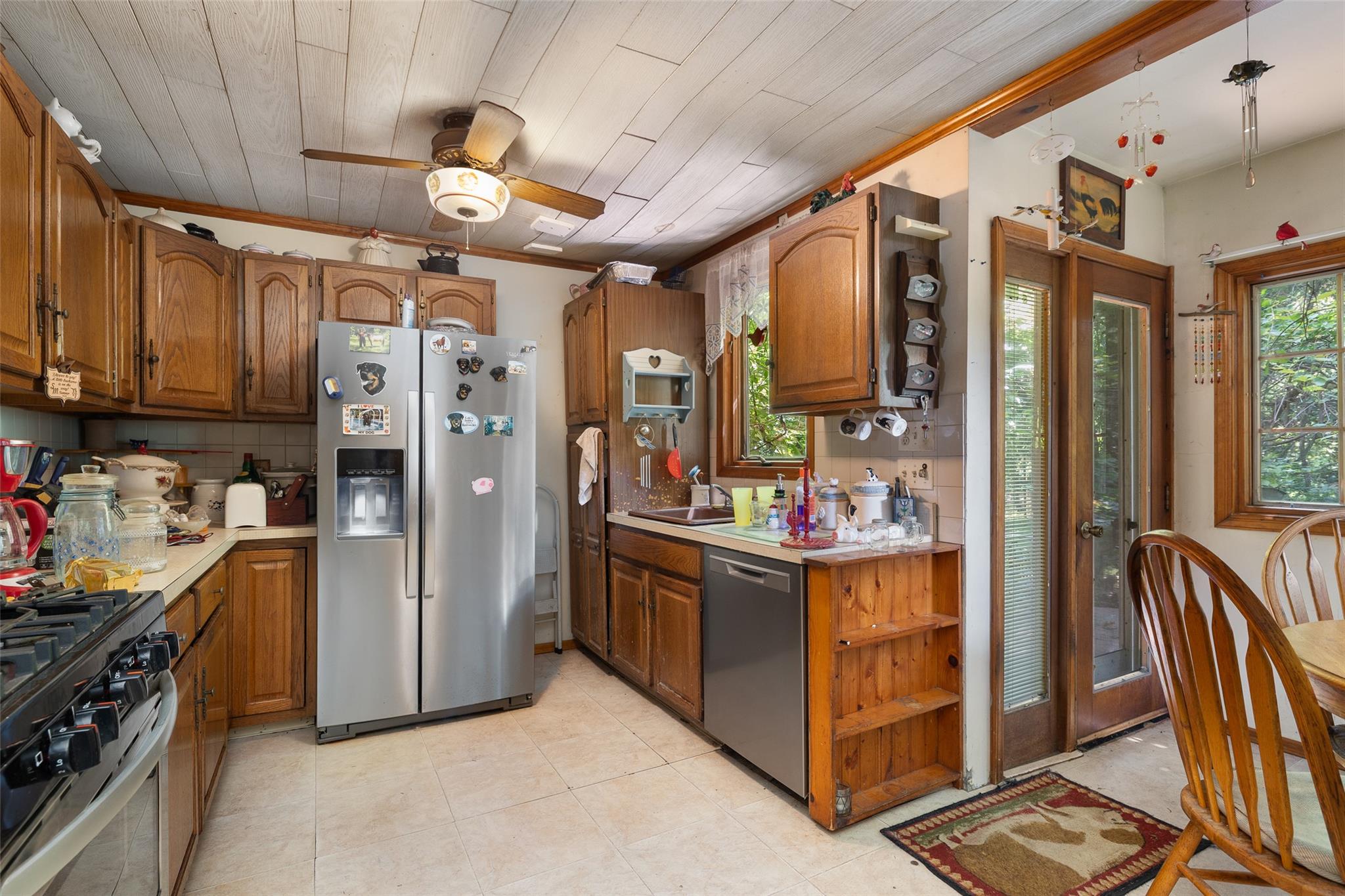 33 North Coleman Road Centereach, NY 11720 - Photo 14 of 40 Kitchen with appliances with stainless steel finishes, a ceiling fan, light countertops, brown cabinetry, and ornamental molding