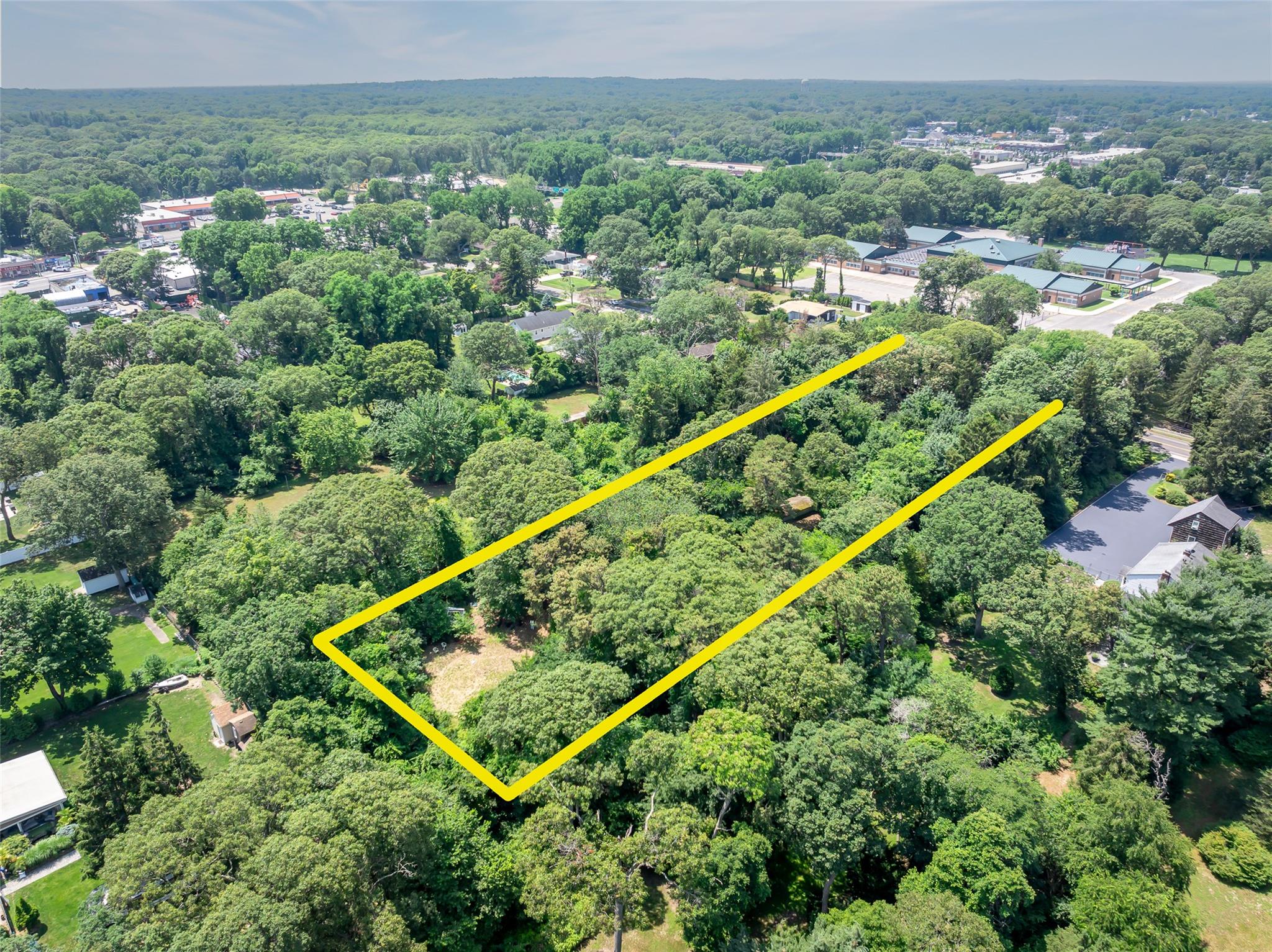 33 North Coleman Road Centereach, NY 11720 - Photo 38 of 40 Aerial view of property's location with a heavily wooded area and property boundaries highlighted