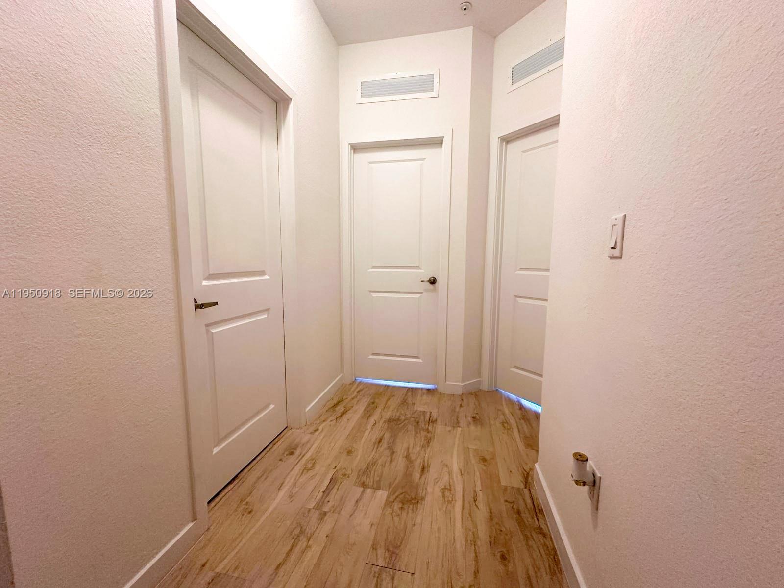 15540 Southwest 136th Street, Unit 204 Miami, FL 33196 - Photo 12 of 21 a view of a room with wooden floor and a bathroom