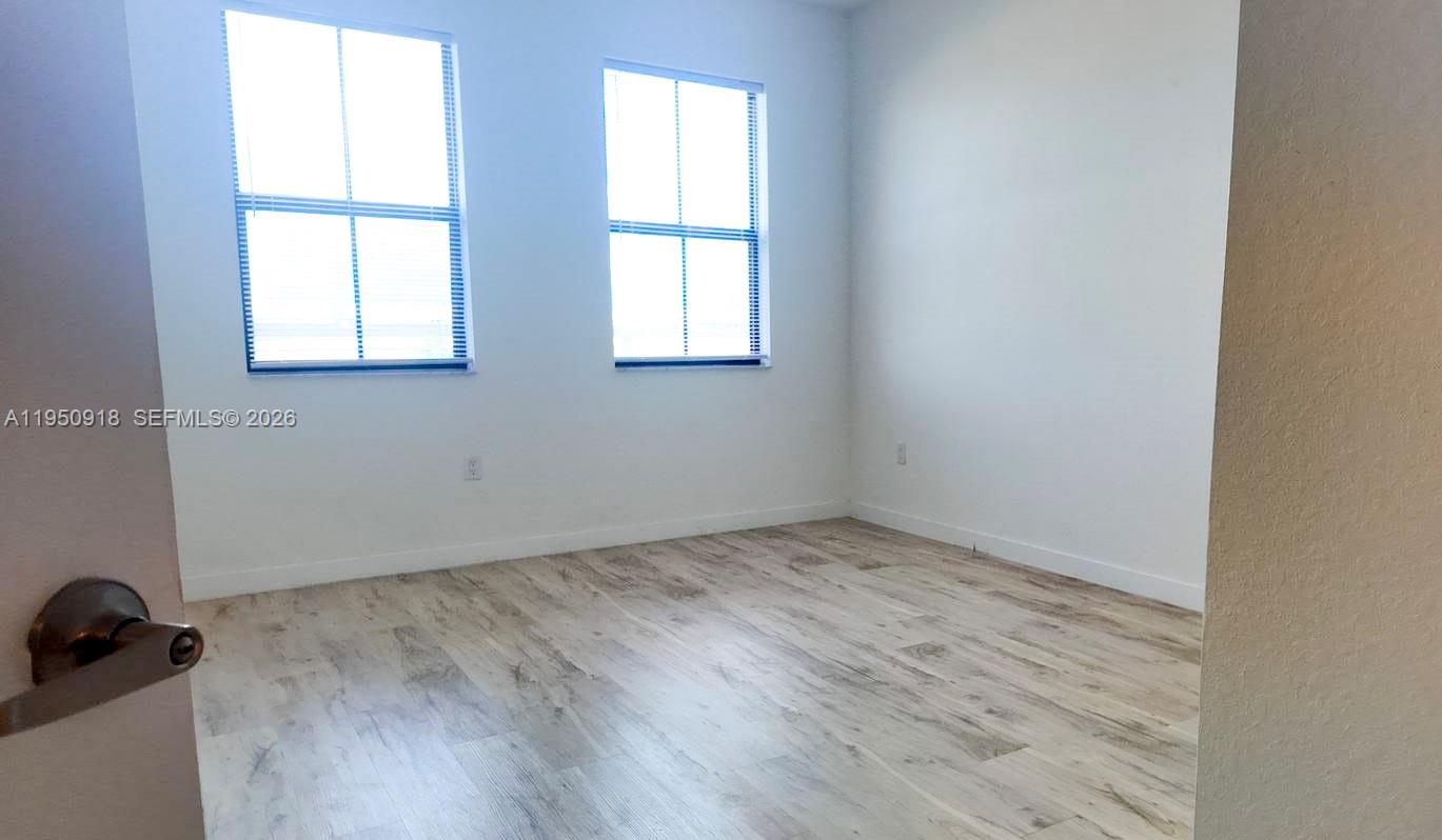 15540 Southwest 136th Street, Unit 204 Miami, FL 33196 - Photo 16 of 21 an empty room with a window