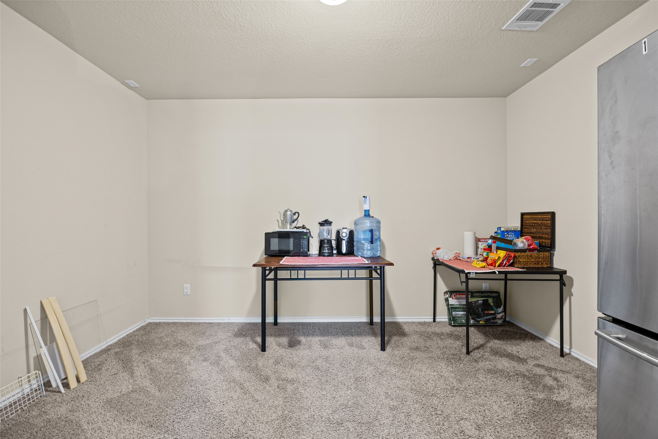 19113 Rookery Trail Pflugerville, TX 78660 - Photo 14 of 36 Spacious room featuring neutral paint, textured carpet flooring, and a ceiling-mounted ventilation system