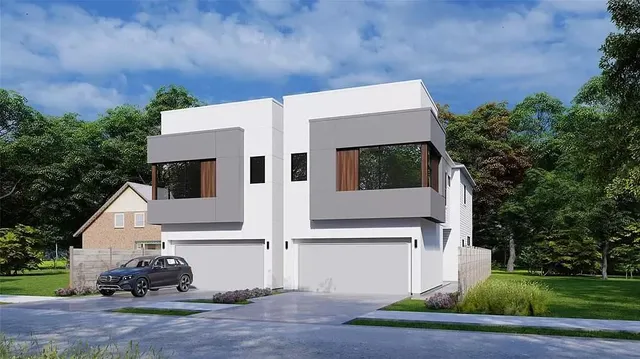 a view of a white house with large windows and plants