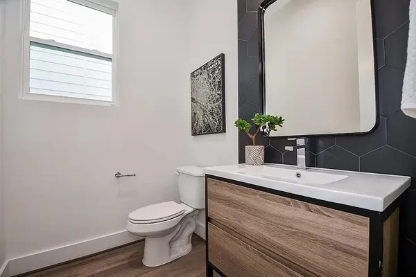 a bathroom with a toilet sink and mirror