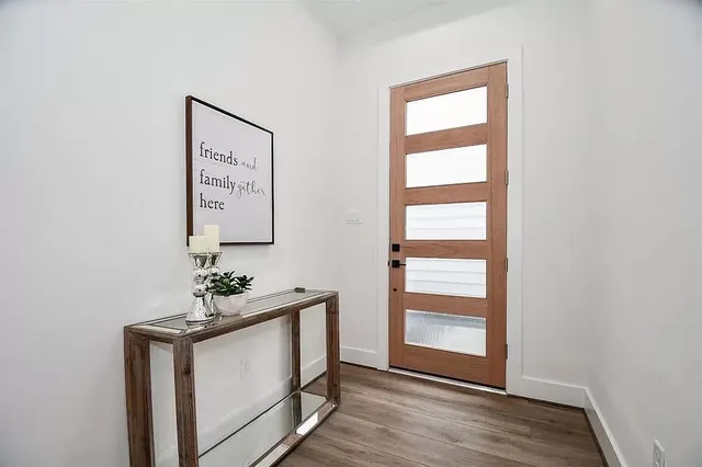 a view of an entryway with wooden floor