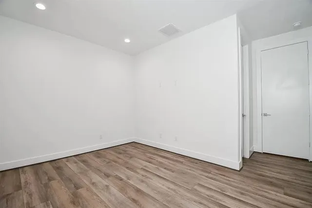 a view of a room with wooden floor