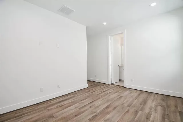 an empty room with wooden floor