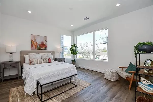a bedroom with a bed window and a table